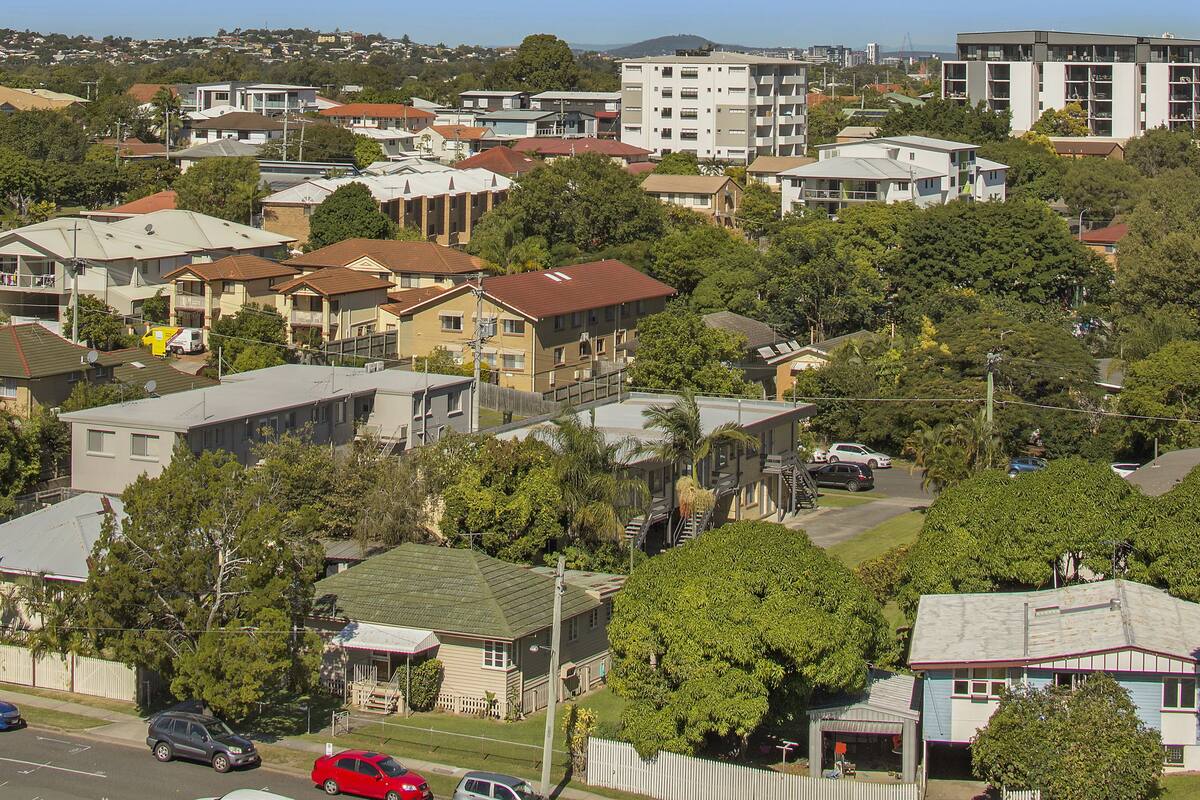 A residential area with various houses and buildings, including a mix of single and multi-story structures.