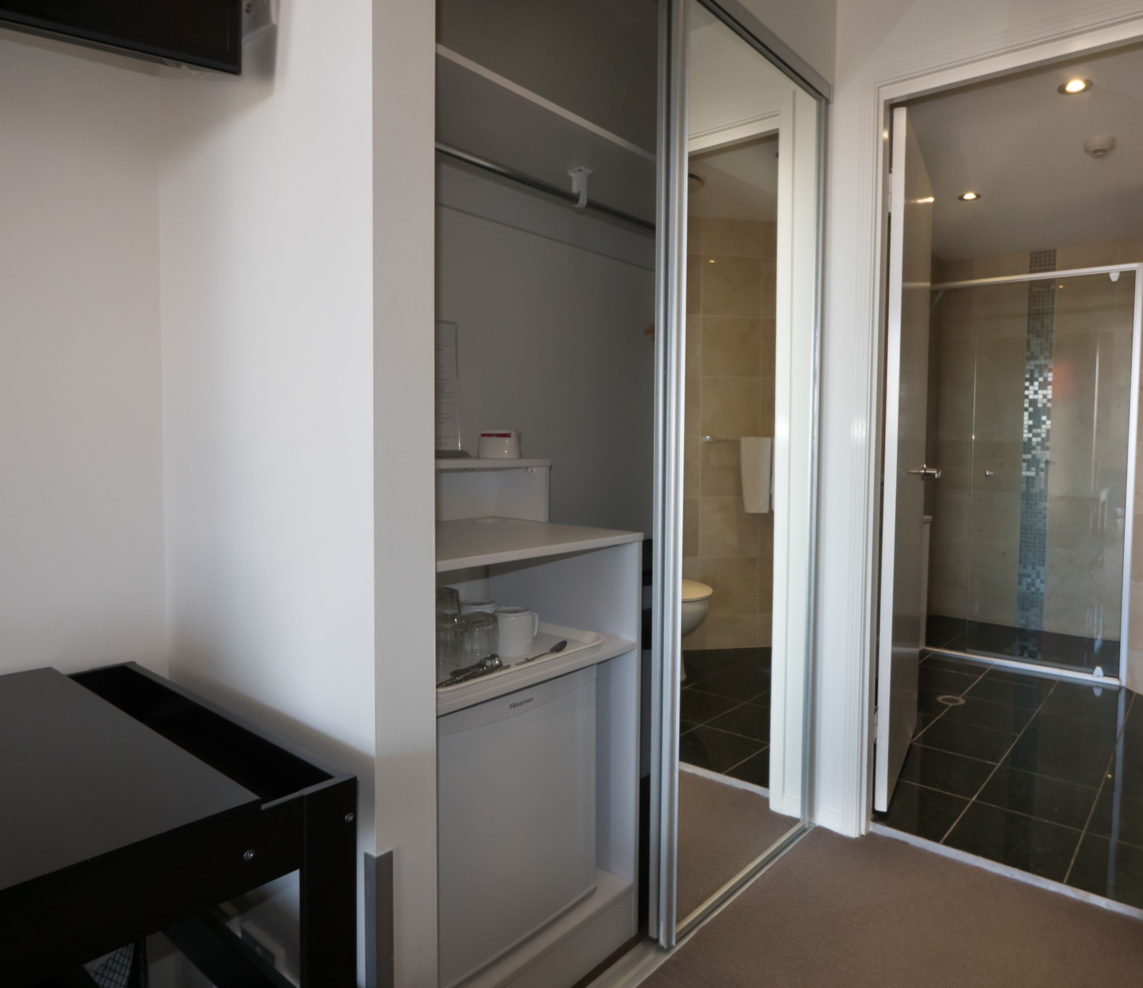 A modern bathroom with a toilet, sink, and shower area.