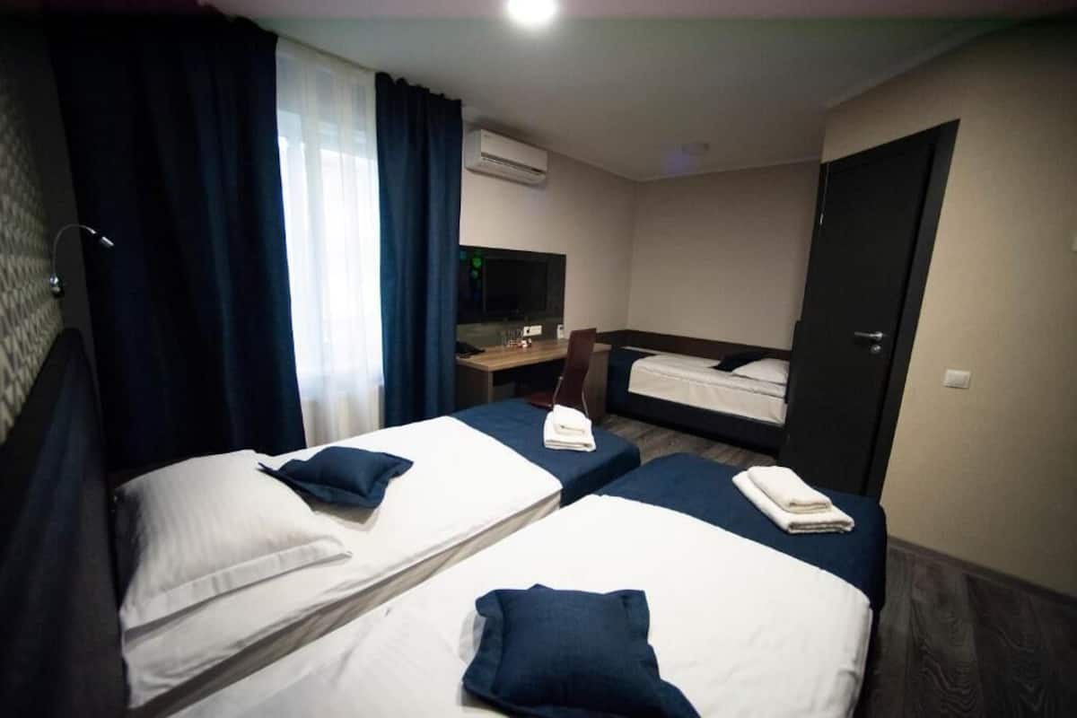 Standard Triple Room | Pillowtop beds, minibar, desk, laptop workspace