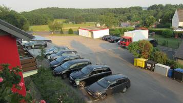 A parking lot with several cars and a red truck.