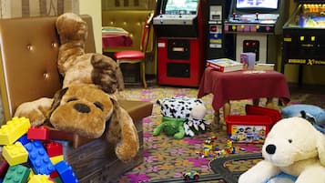 Children can play and explore in this vibrant play area with toys, arcade games, and a cozy reading nook.