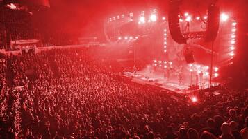 A large indoor venue with a stage and audience.