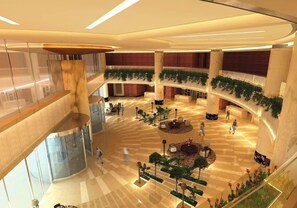 A spacious atrium with multiple levels, featuring a central seating area, plants, and a modern design. - Crowne Plaza Tianjin Binhai Center by IHG (Tianjin)