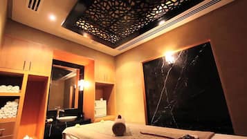 Relax in a stylish room with a large bed, mirror, and shelving.