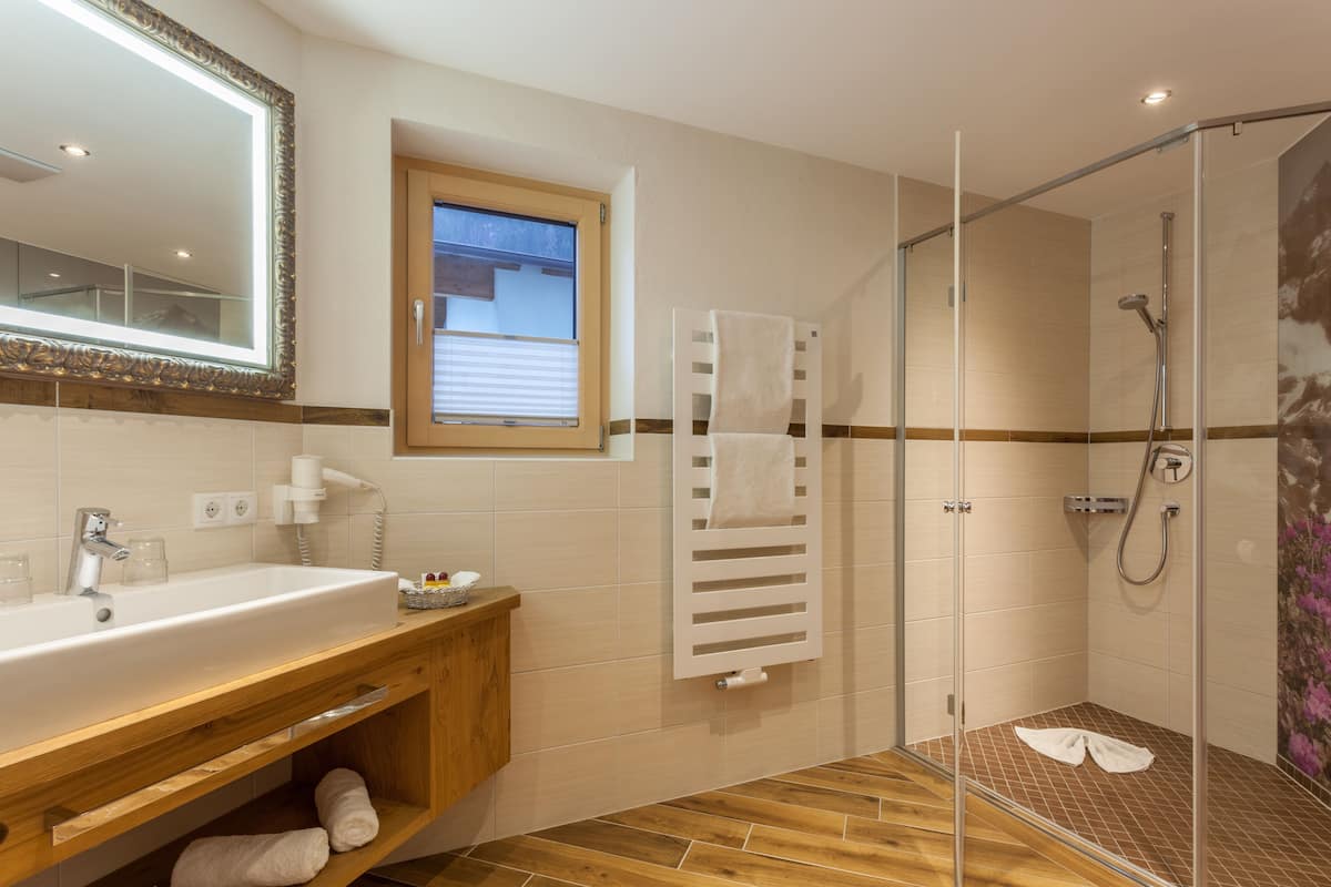 deluxe family room, balcony, mountain view | bathroom | free toiletries, hair dryer, towels, shampoo