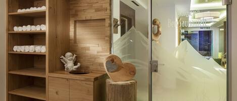 A wooden vanity with shelves, a mirror, and a wooden stump.