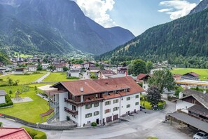 A mountain village with traditional architecture, a central square, and a playground.