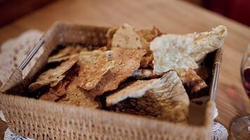 A basket of assorted crackers on a wooden table.