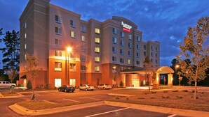 A multi-story Fairfield Inn & Suites hotel with a parking lot in front.