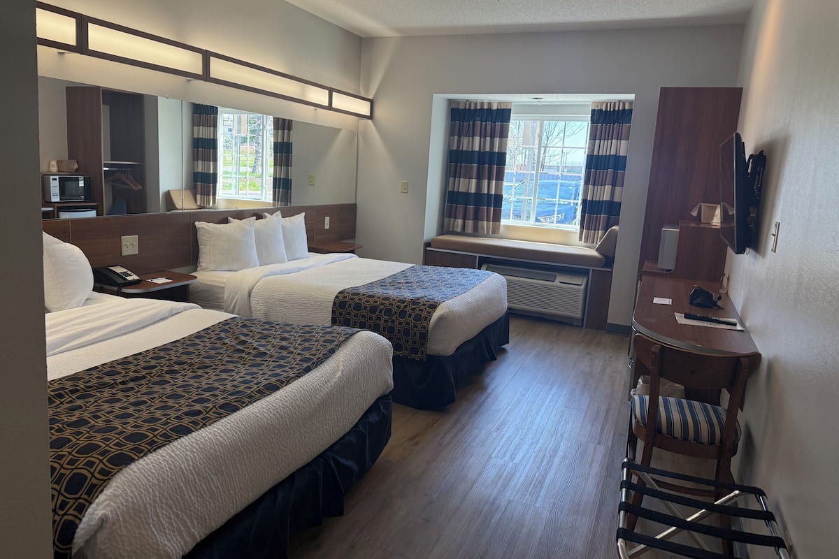 Hypo-allergenic bedding, desk, laptop workspace, blackout curtains