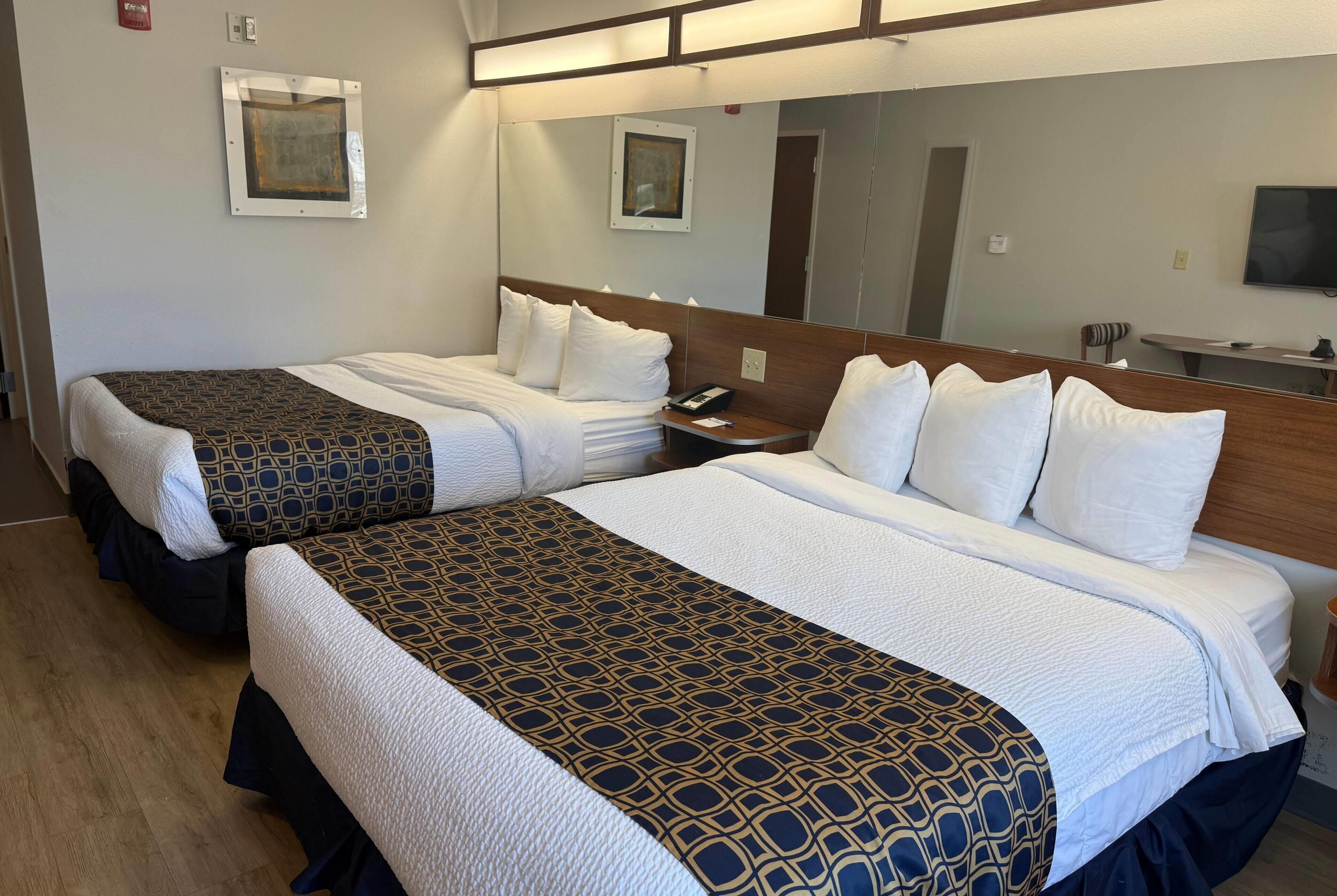 Hypo-allergenic bedding, desk, laptop workspace, blackout drapes