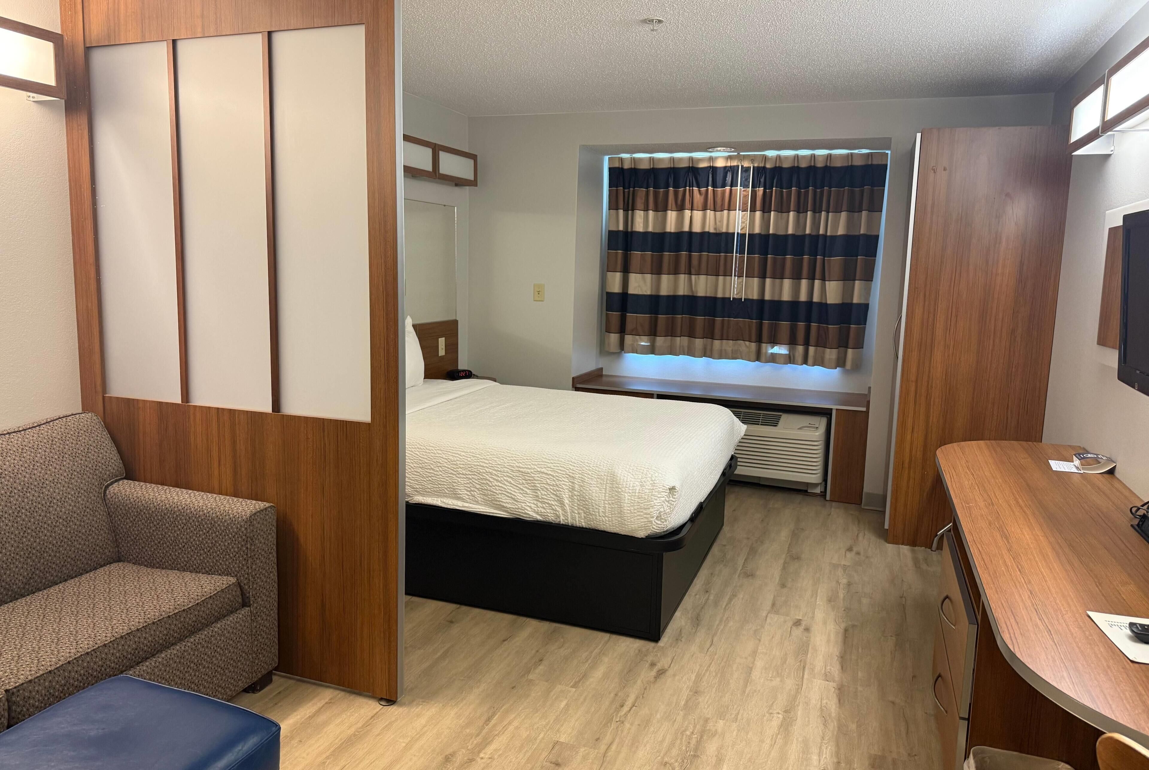 Hypo-allergenic bedding, desk, laptop workspace, blackout drapes