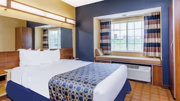Hypo-allergenic bedding, desk, laptop workspace, blackout drapes