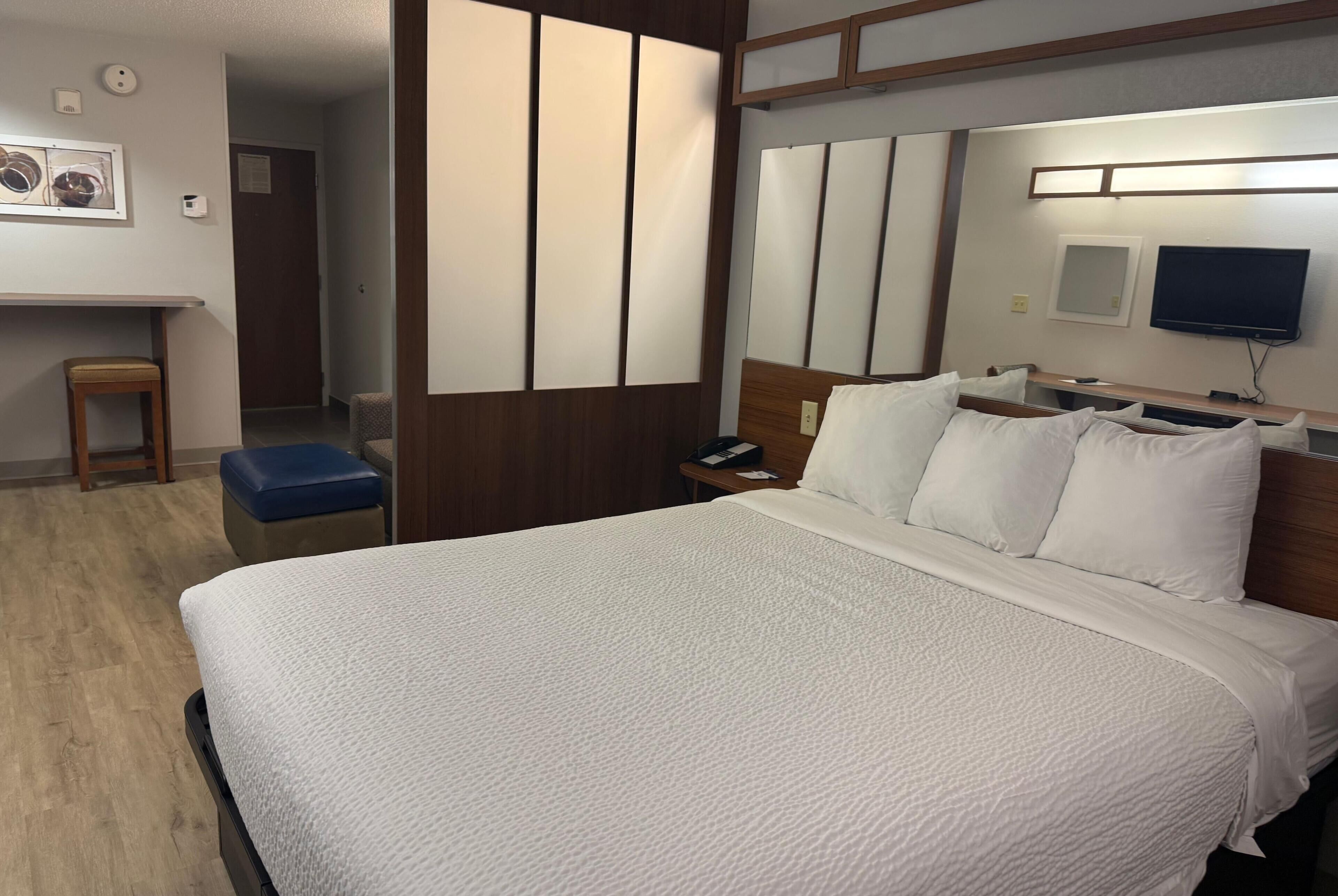 Hypo-allergenic bedding, desk, laptop workspace, blackout drapes