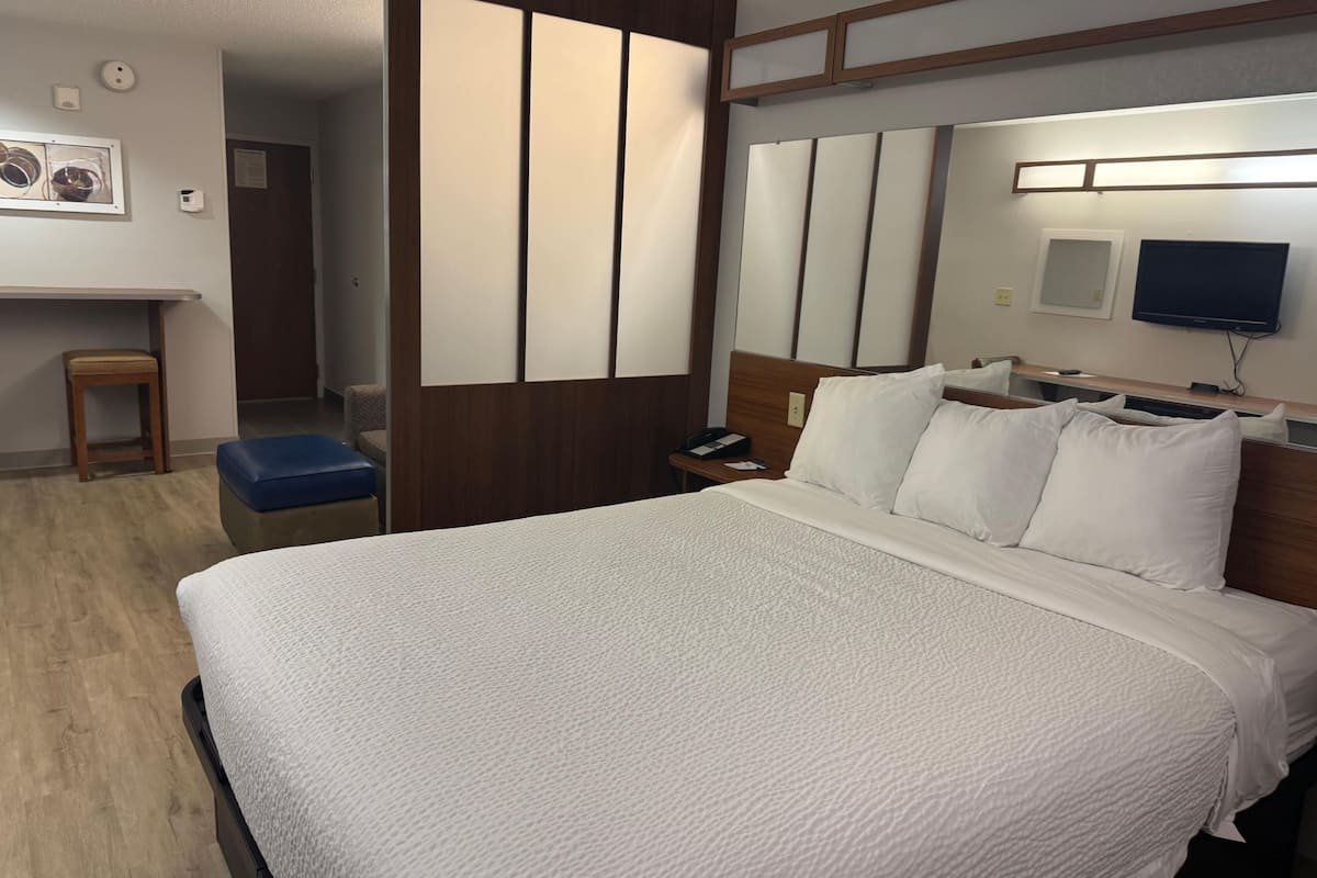 Hypo-allergenic bedding, desk, laptop workspace, blackout drapes