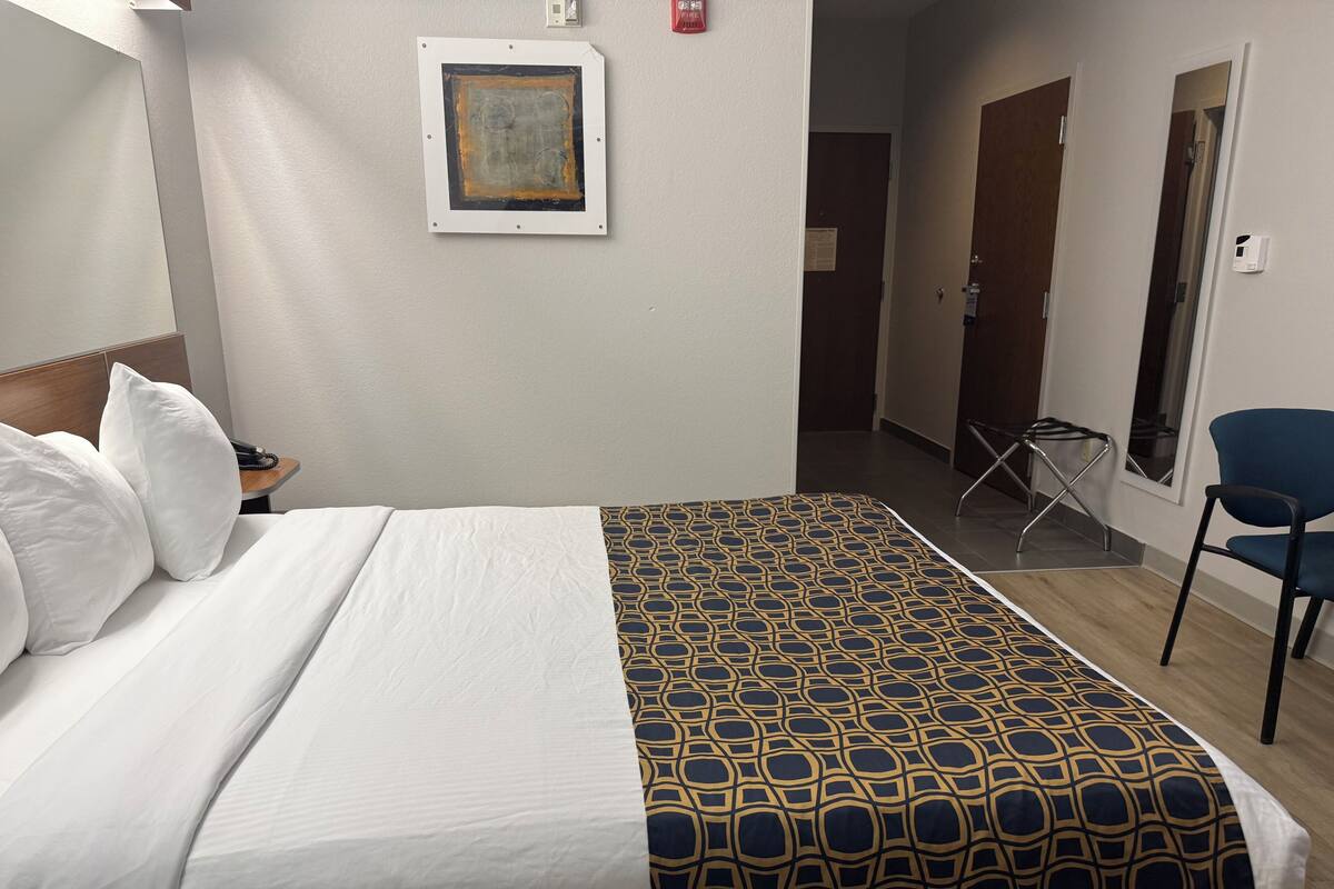 Hypo-allergenic bedding, desk, laptop workspace, blackout curtains