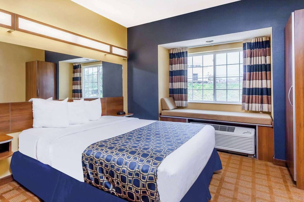 Hypo-allergenic bedding, desk, laptop workspace, blackout curtains