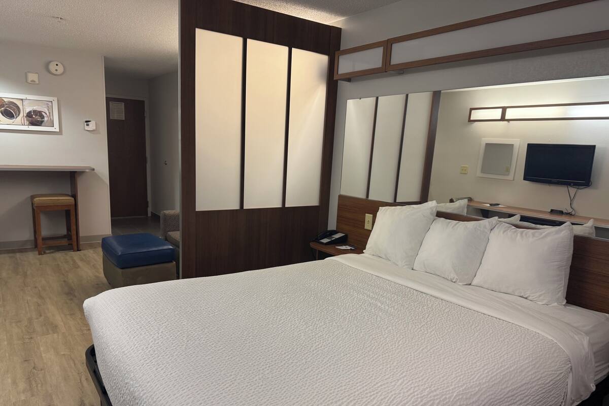 Hypo-allergenic bedding, desk, laptop workspace, blackout curtains
