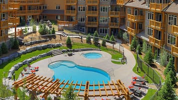 Residents can enjoy a refreshing swim in the central courtyard pool surrounded by a pergola and outdoor seating.