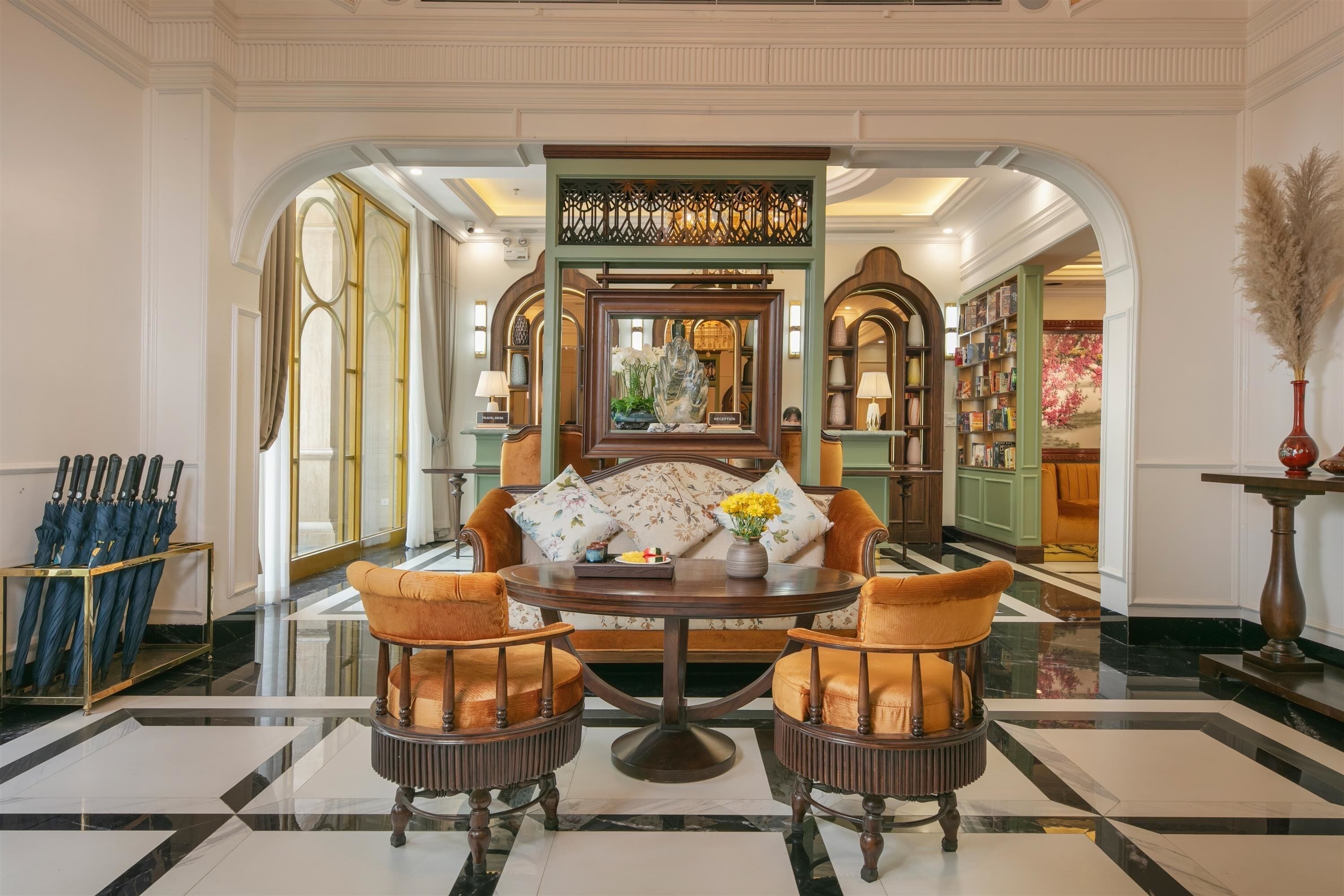 A formal dining area with a round table, two chairs, and a decorative mirror.