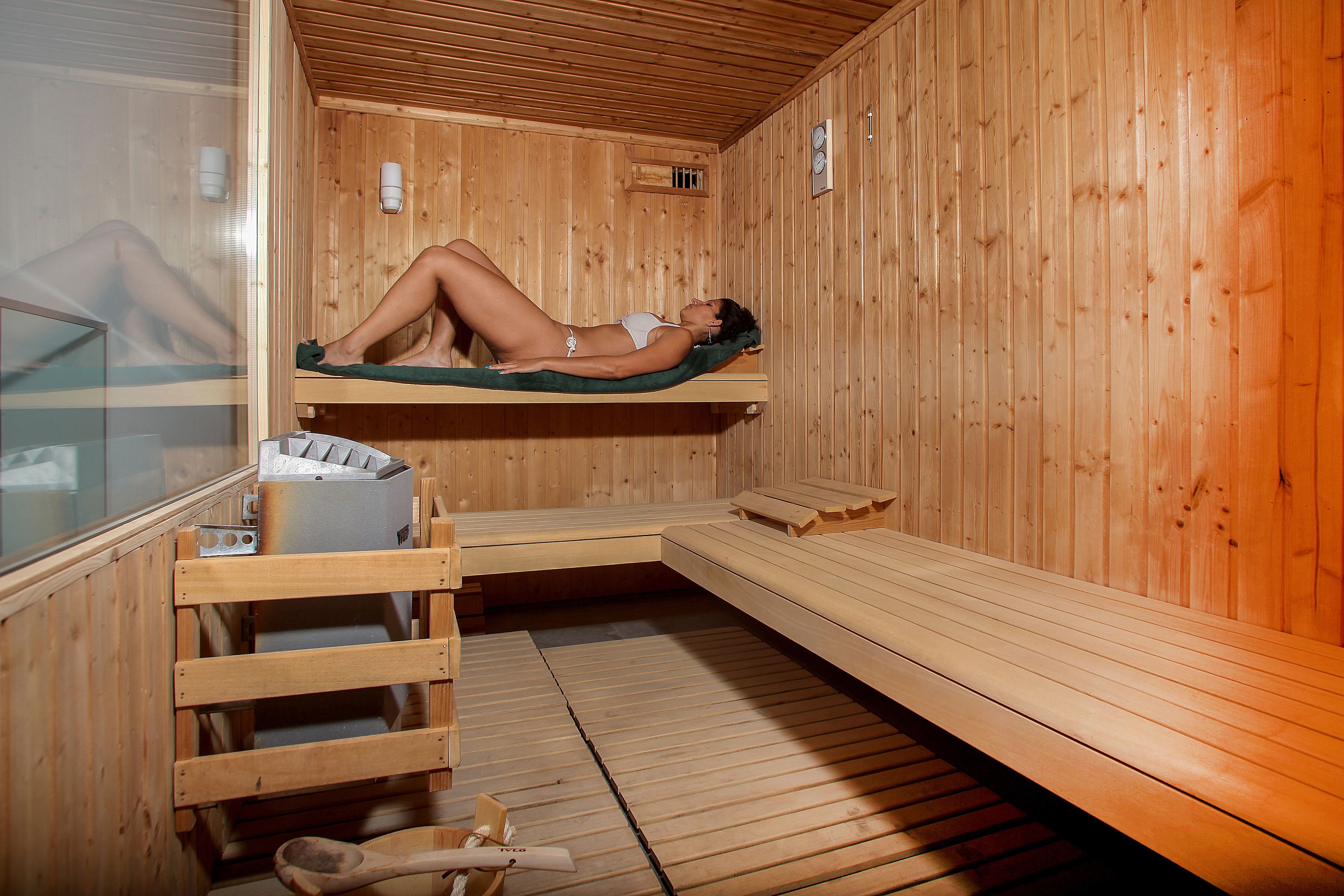A sauna room with wooden walls and benches.