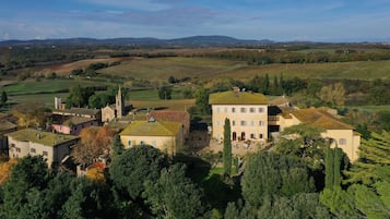 A rural village with traditional architecture, including a church and several buildings with terracotta roofs.
