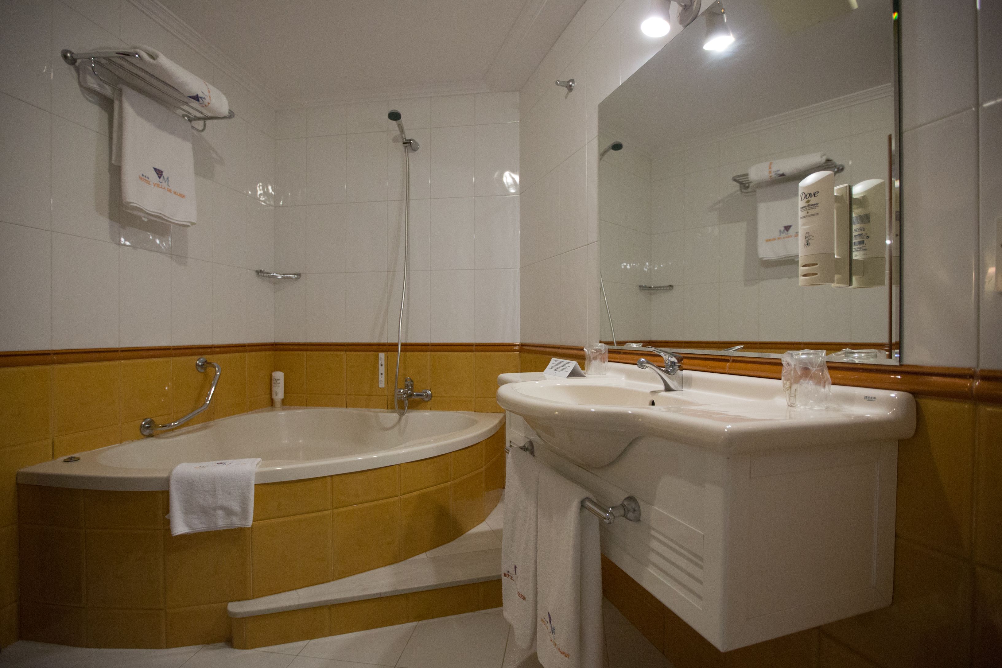 A bathroom with a bathtub, a sink, and a shower.