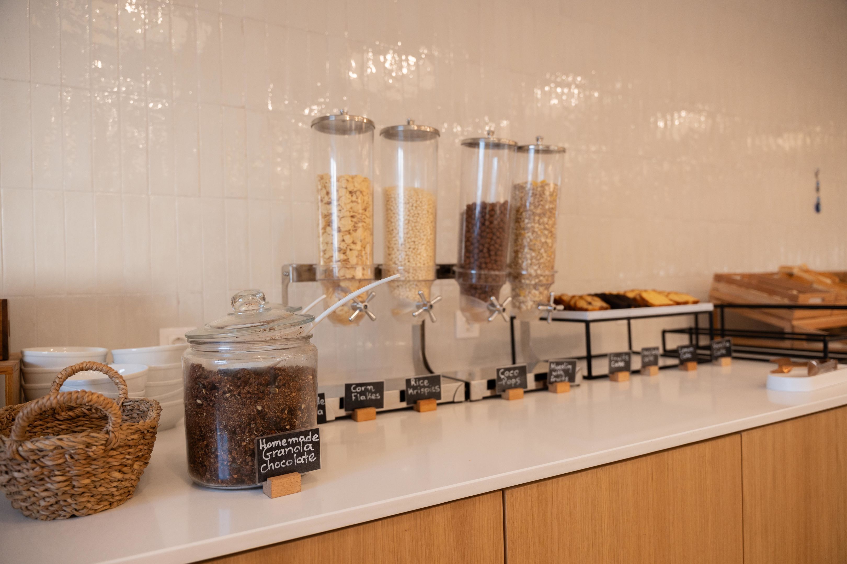 A coffee station with various grains and a homemade granola chocolate latte option.