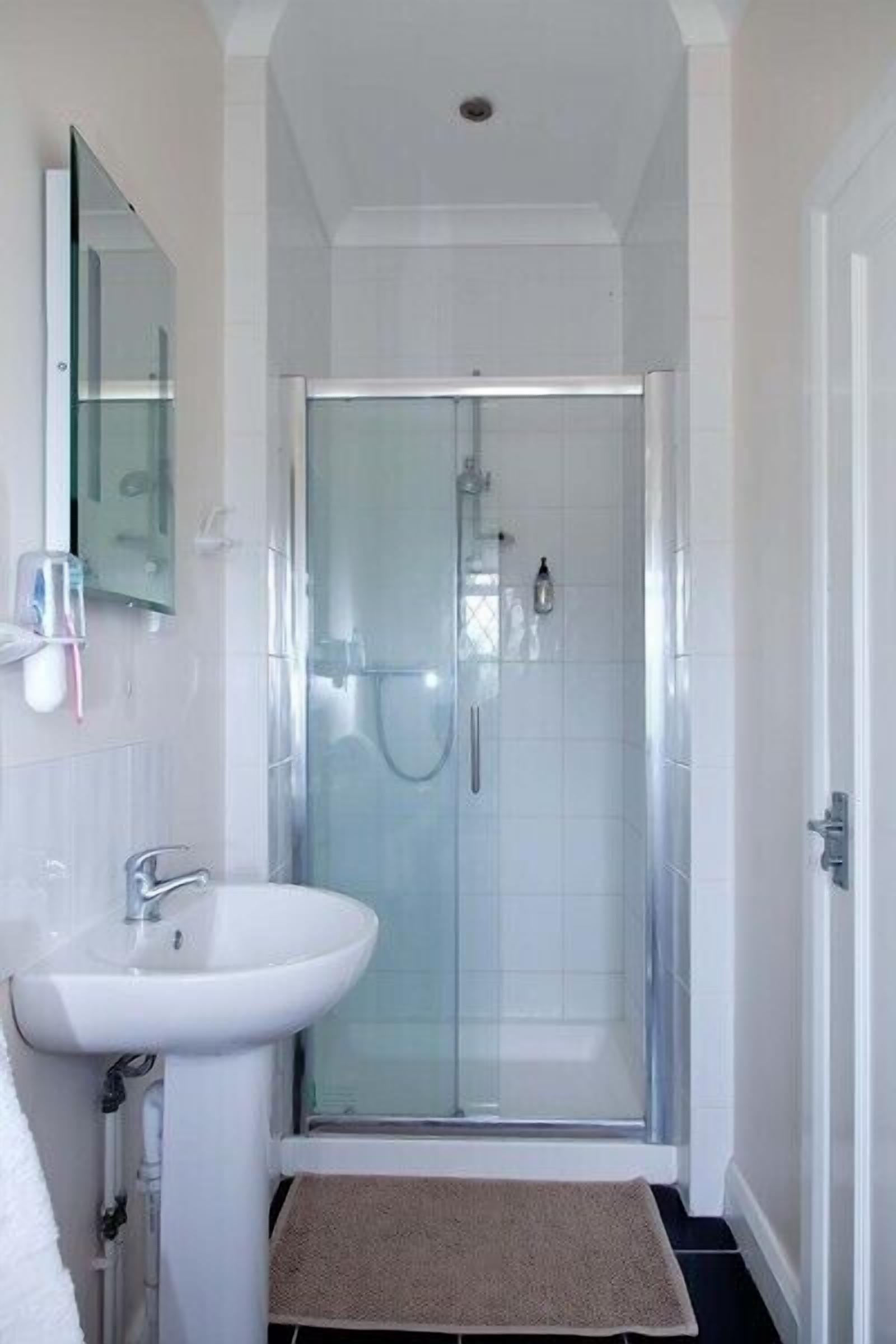 Shower, designer toiletries, towels, toilet paper