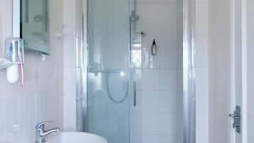 Shower, designer toiletries, towels, toilet paper
