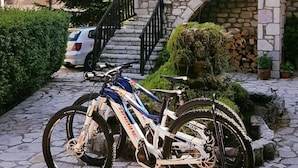 A stone building with a staircase and a parked bicycle.