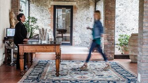 A rustic interior with a wooden table, a potted plant, and a large window. - Villa Acquaviva Wine Resort (Manciano)