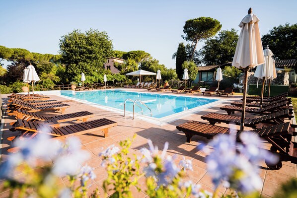 Seasonal outdoor pool, open 9:00 AM to 7:00 PM, pool umbrellas