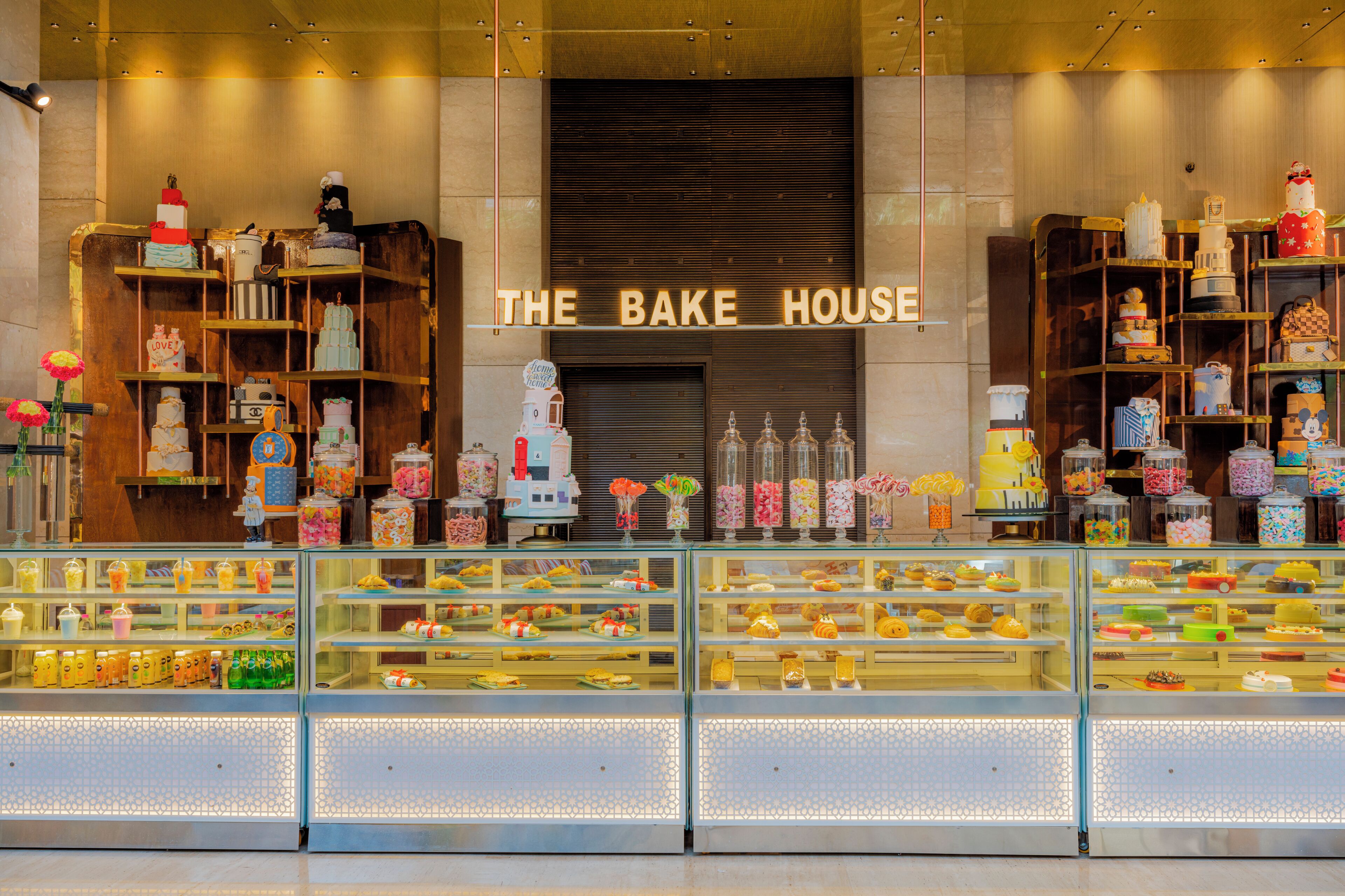 A bakery display with various cakes and pastries.