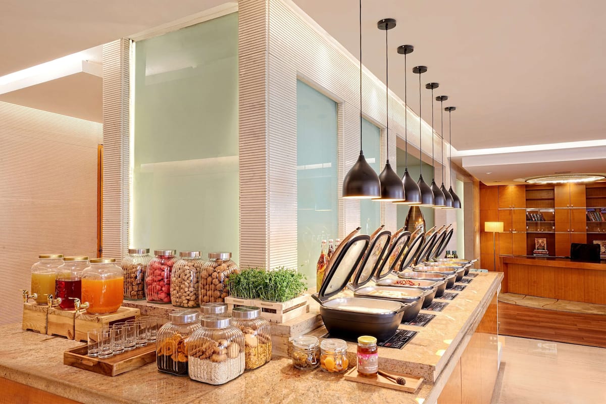 A buffet area with various food items and beverages.