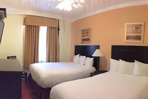 A hotel room with two beds, a nightstand with a lamp, and a window with curtains. - Post Hotel (San Francisco)