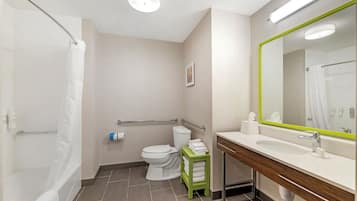 A modern bathroom with a bathtub, toilet, and sink.