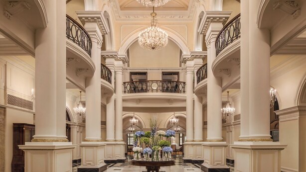 A grand lobby with a high ceiling, large chandeliers, and a central floral arrangement. - Waldorf Astoria Shanghai on the Bund (Shanghai)