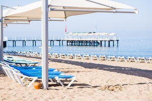 On the beach, sun loungers, beach umbrellas, beach towels