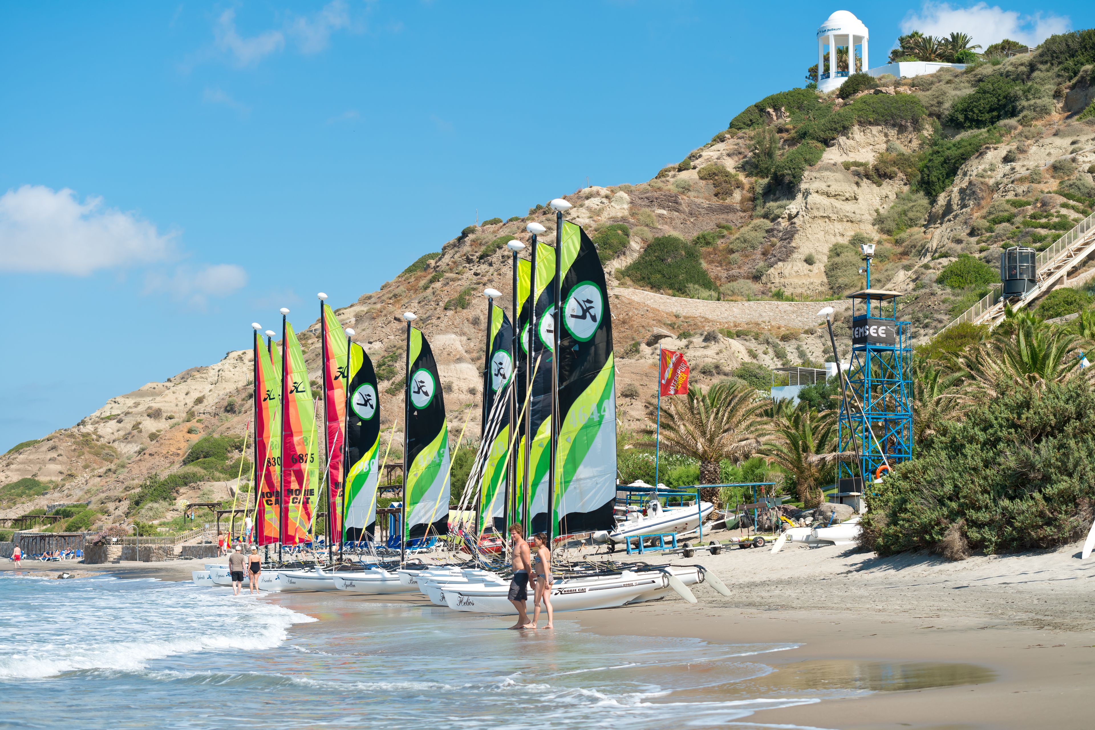 on the beach, white sand, free beach cabanas, sun-loungers