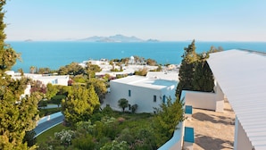 A coastal resort with white buildings, a view of the sea, and lush greenery. - ROBINSON DAIDALOS (Kos)