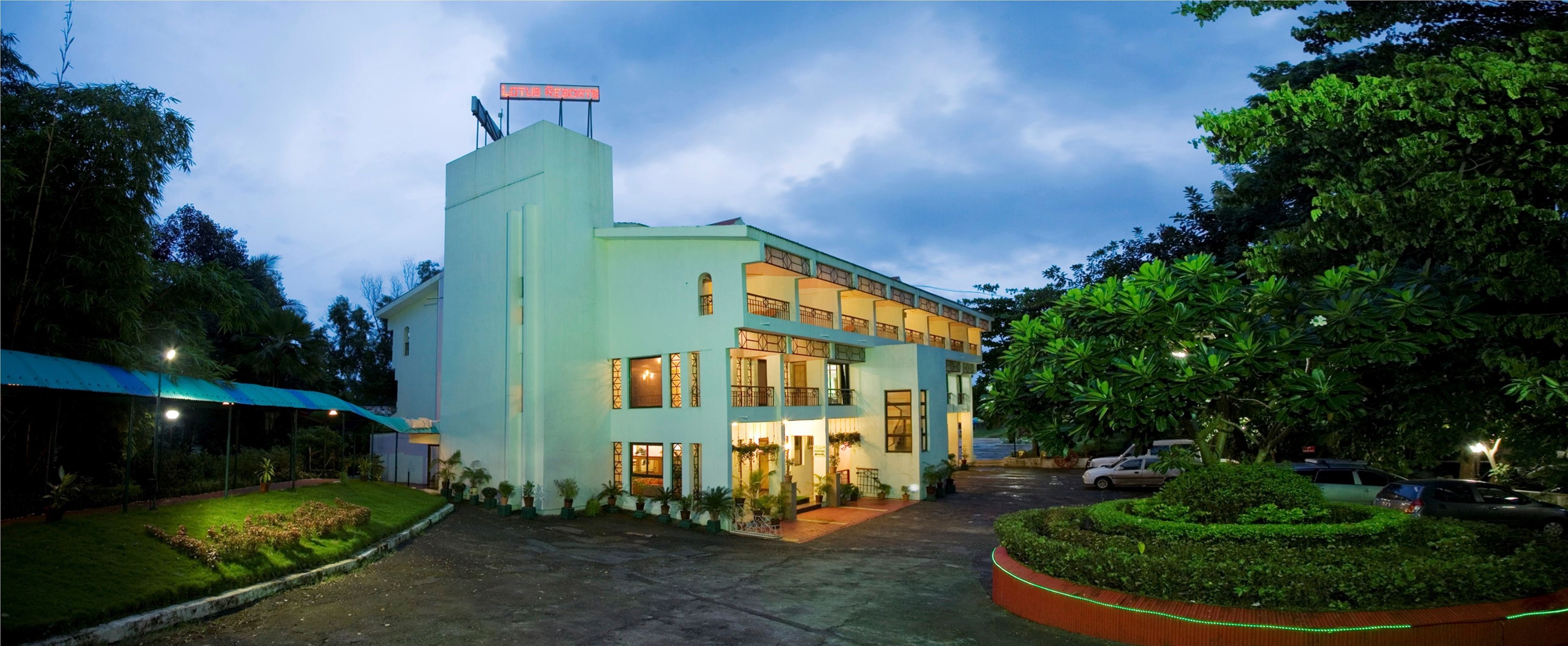 A two-story building with a flat roof and a sign on top.