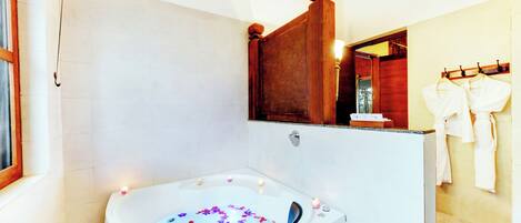 A modern bathroom with a freestanding bathtub, a wooden vanity, and a mirror above the sink.
