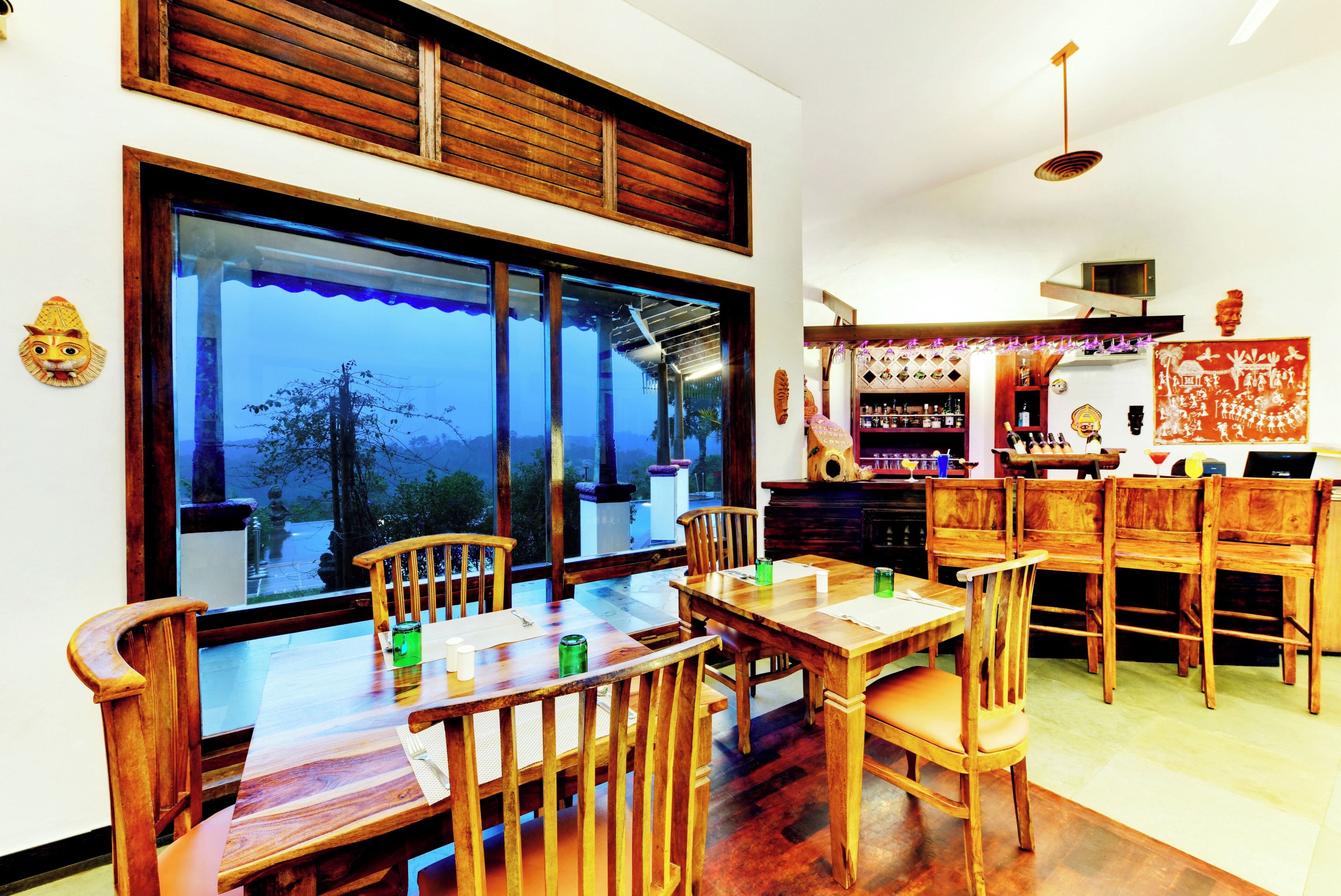 A dining area with wooden furniture and a view of the outdoors.