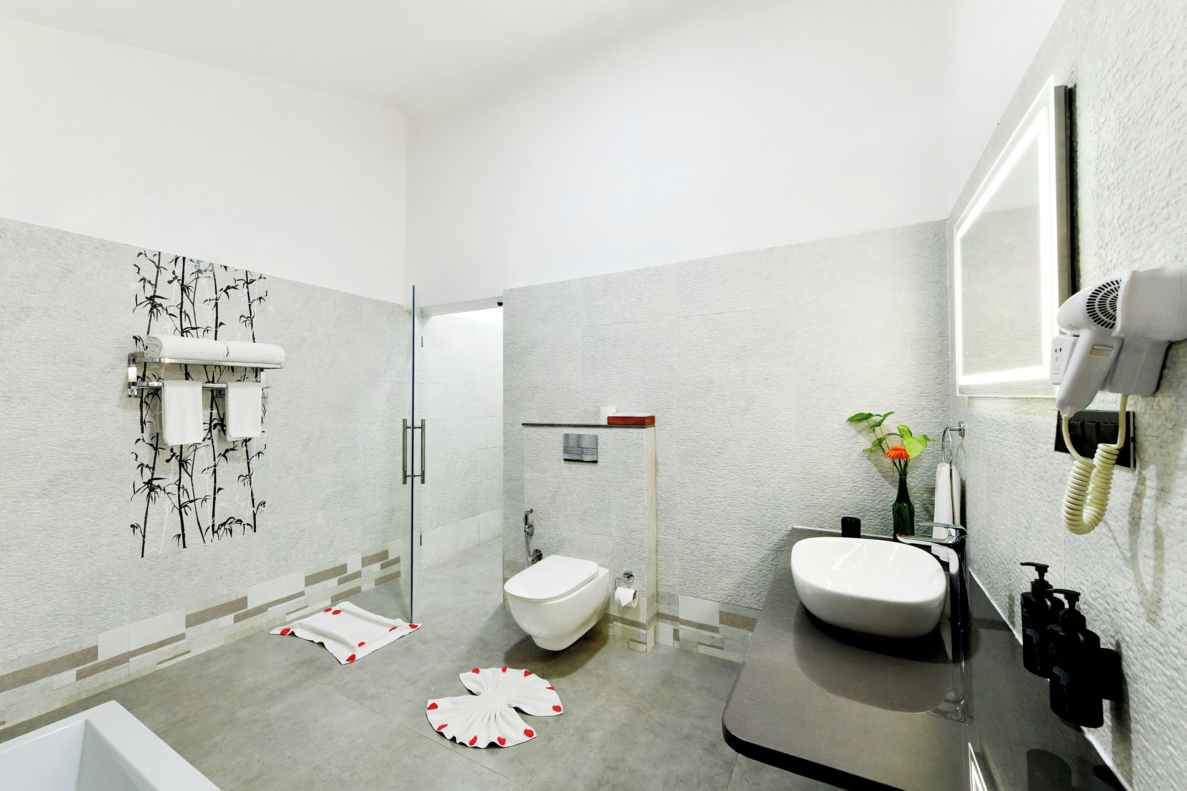 A modern bathroom with a toilet, sink, and shower area.