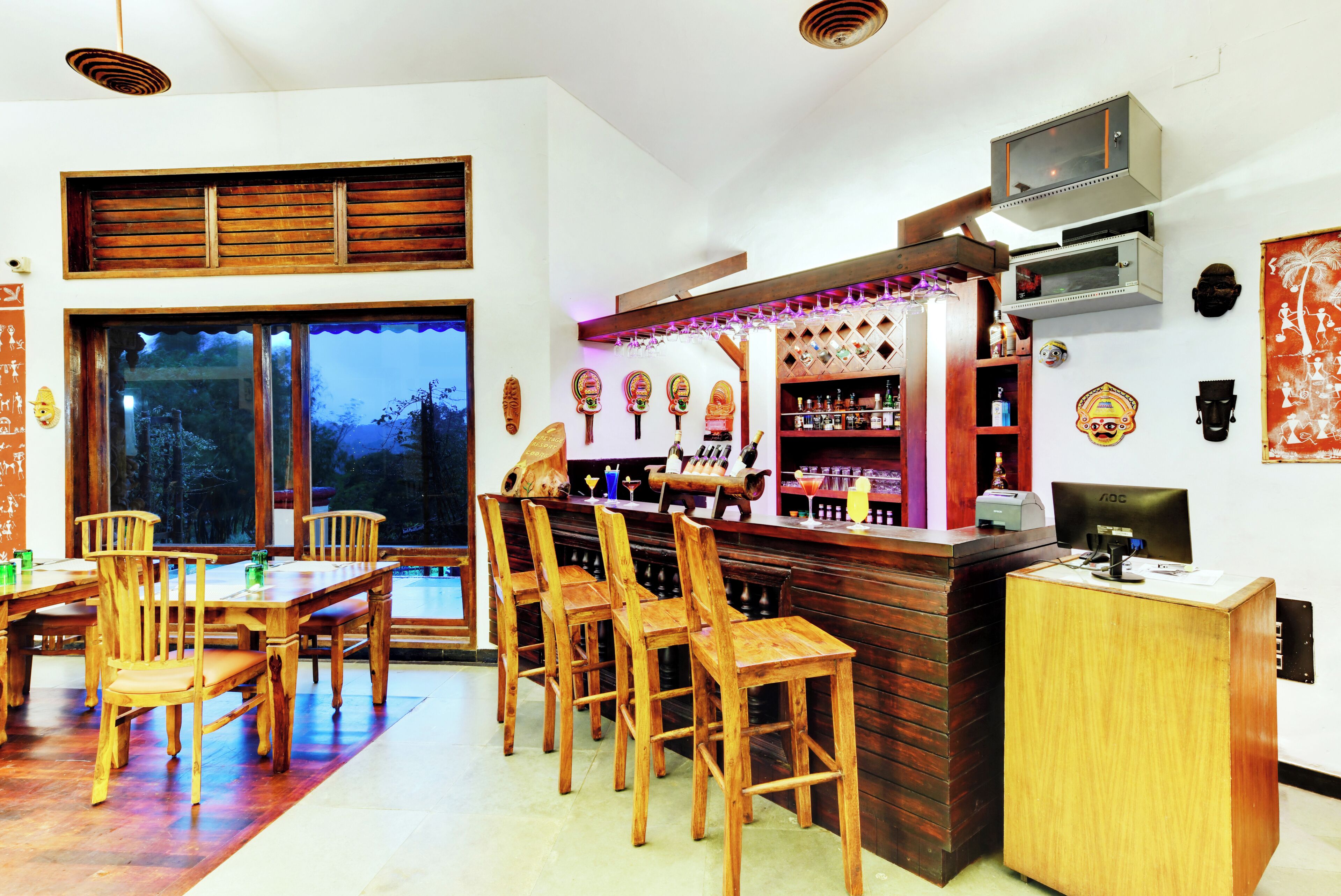 A bar area with wooden furniture, a counter, and various bar items.