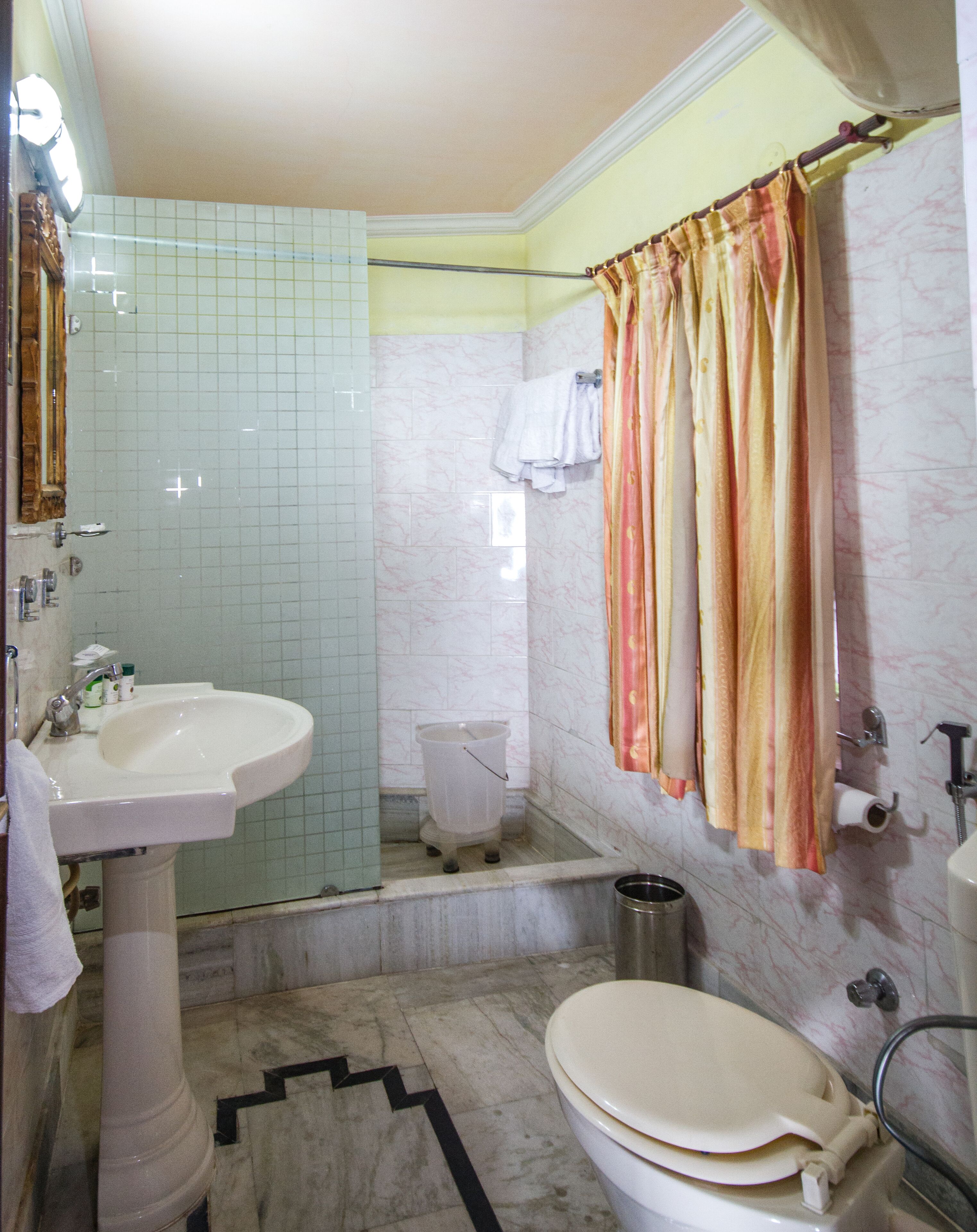 designer toiletries, hair dryer, slippers, towels