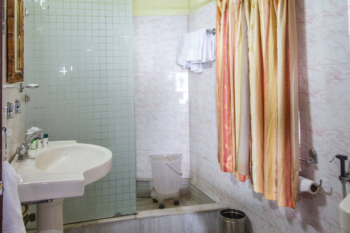 designer toiletries, hair dryer, slippers, towels