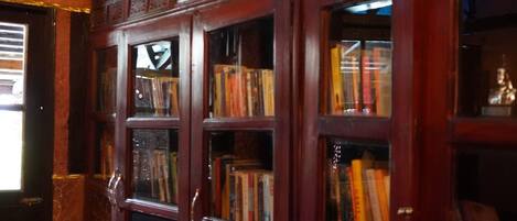 A library with wooden bookshelves containing books.
