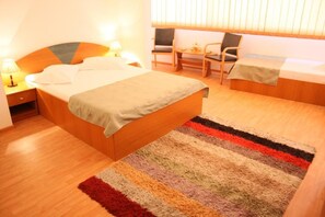 A hotel room with a large bed, a smaller bed, a desk, and a chair. - Sir Lujerului (Bucharest)